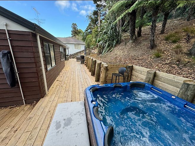 Timber retaining wall beside a deck and spa area