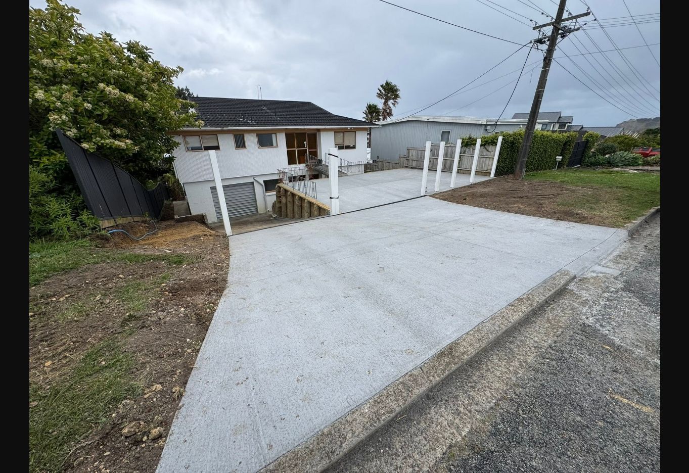 Timber retaining wall beside a concrete path